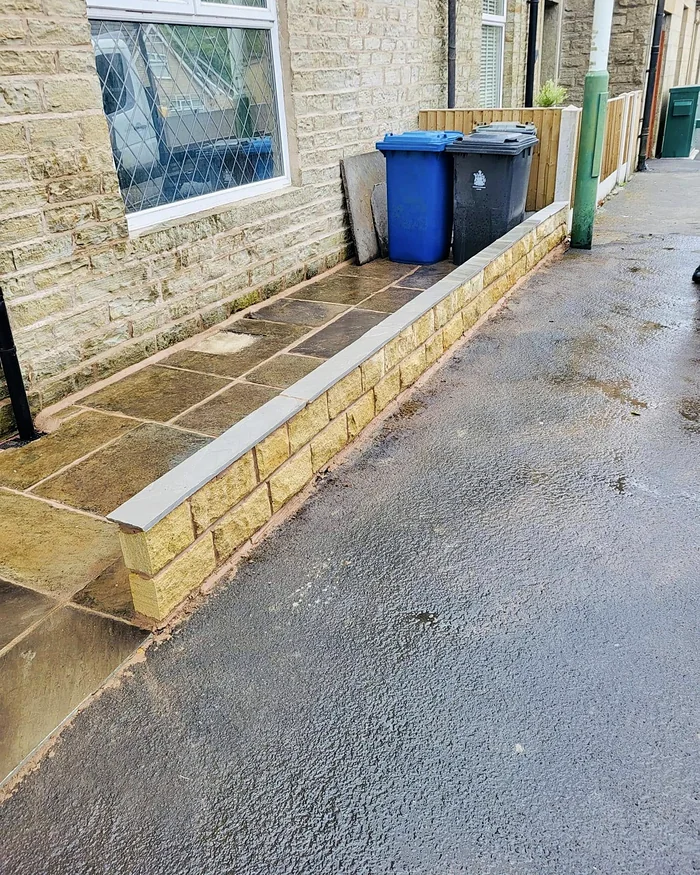 Relaid York stone and a rebuilt low wall along the front