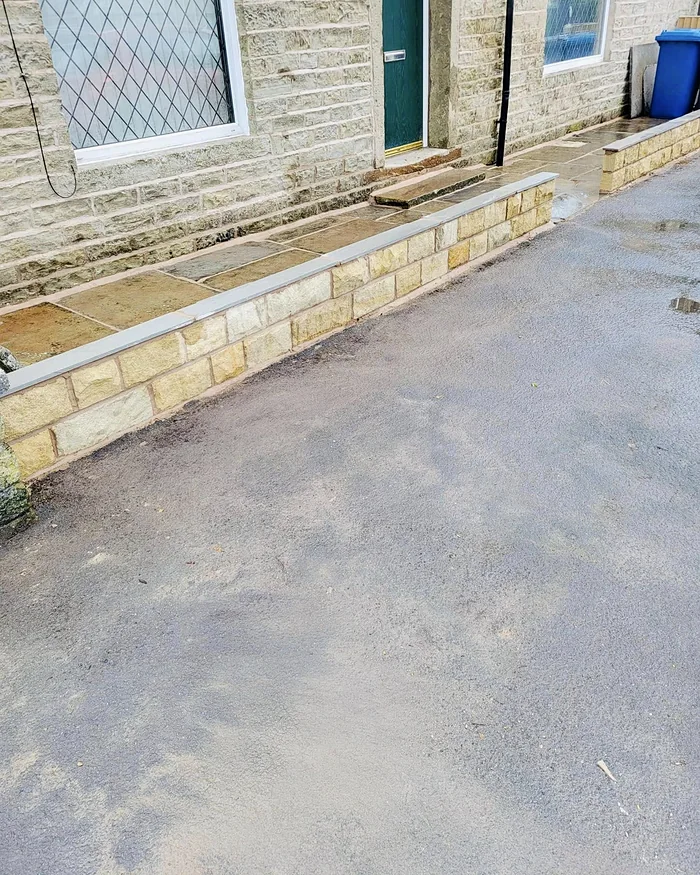 The rebuilt low wall along the front